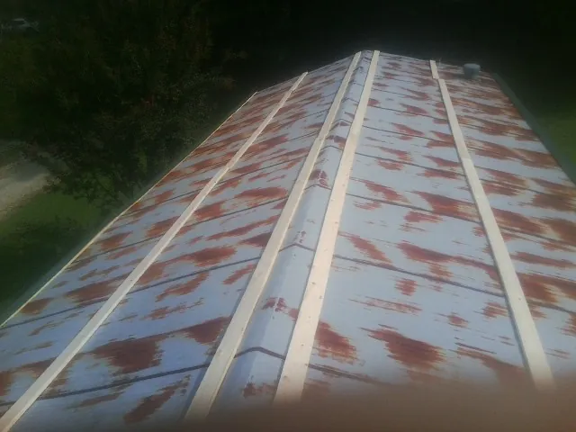 Rusted metal roof panels with new wood purlins before replacement — Storm Damage Roof Repair in New Bloomfield by Roofing Brothers
